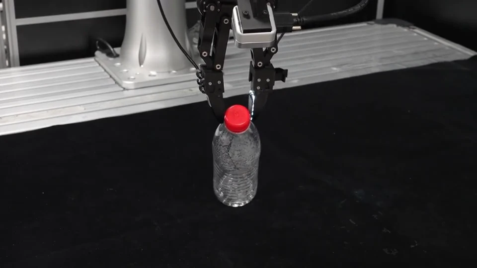 Robot manipulating an empty plastic bottle